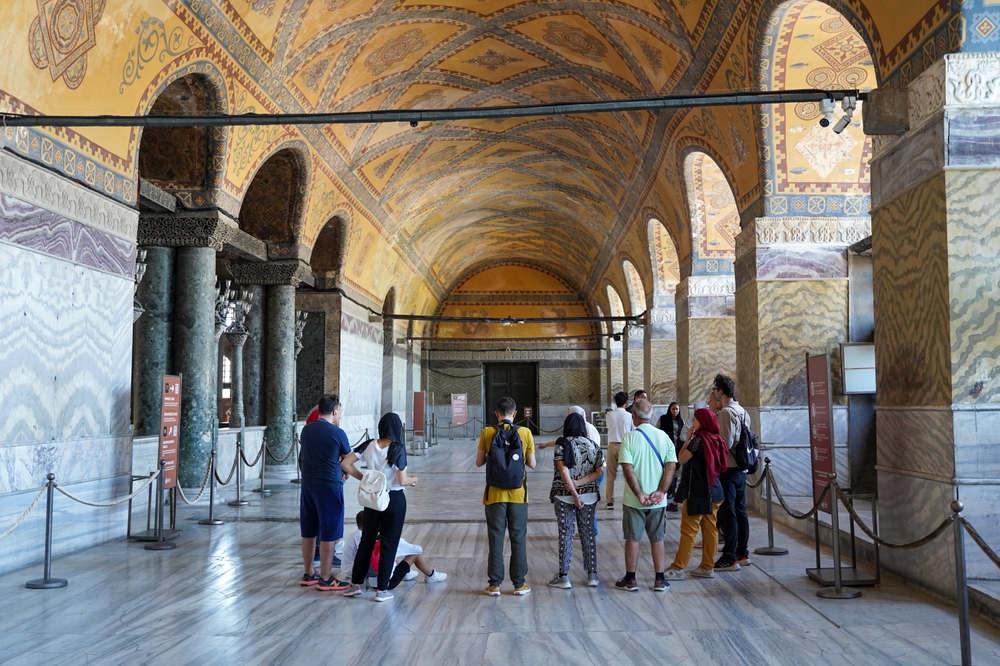 Tourists inside Hagia Sophia following a guided visit route through the historic interior in Istanbul